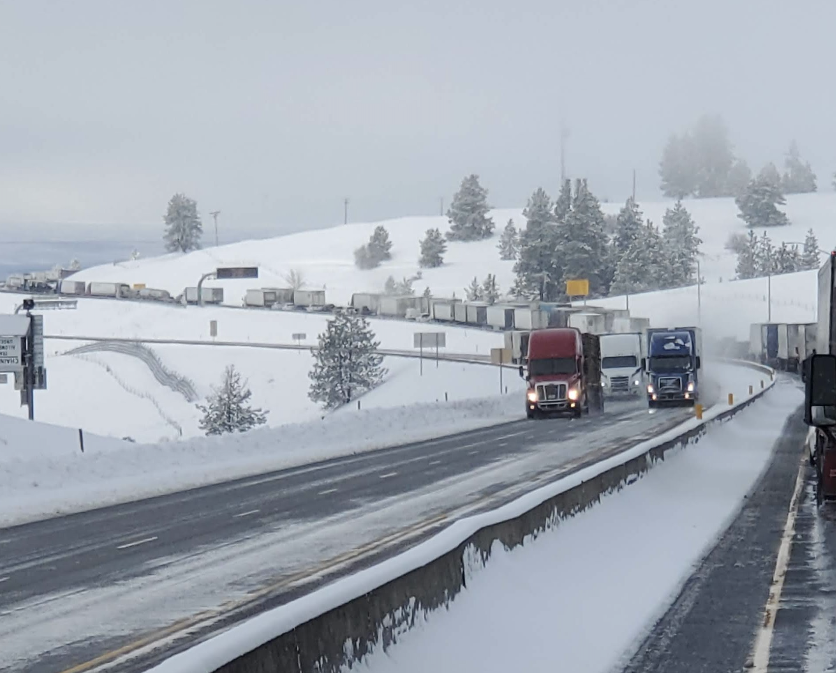 Trucks on a snowy mountain highway